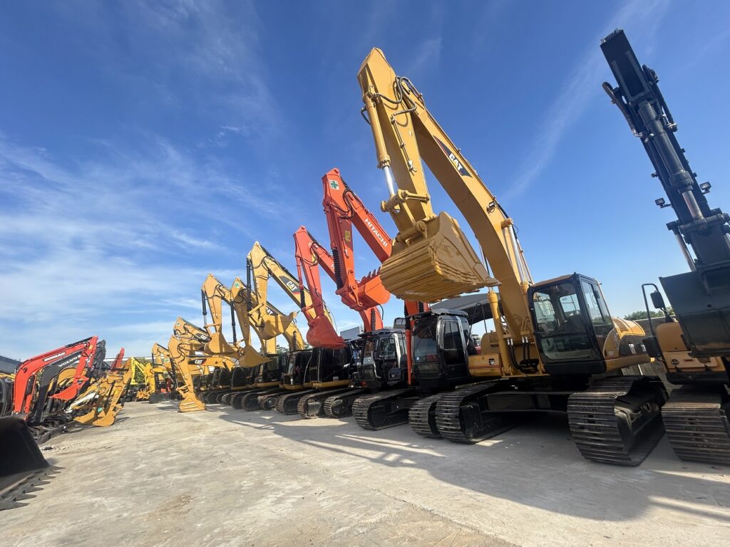 Fleet of multi-brand used excavators including CAT and Hitachi lined up in our Shanghai equipment yard